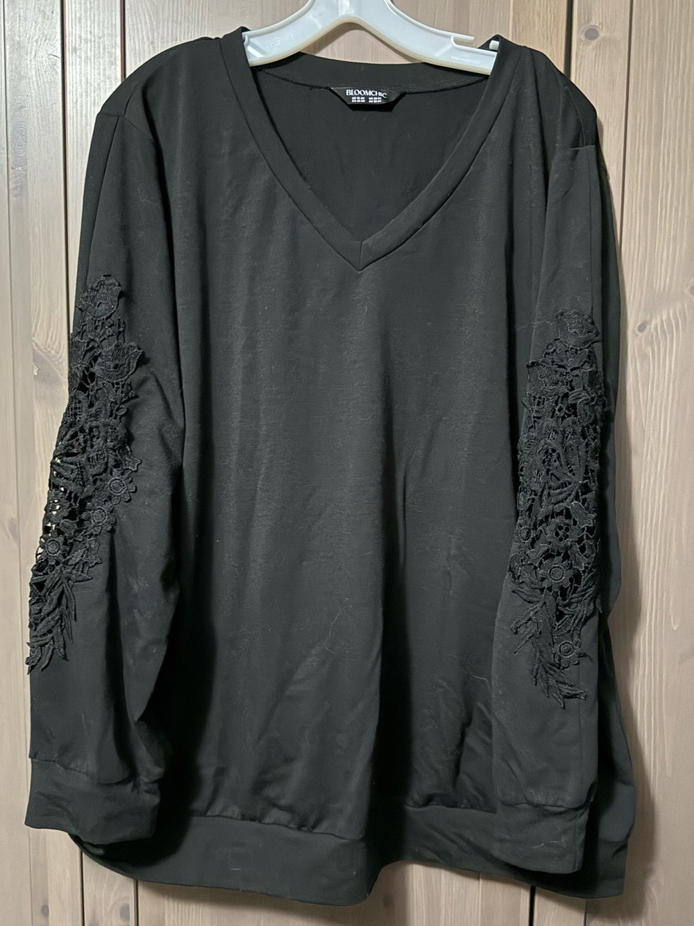 BloomChic Black V-Neck Sweatshirt with Lace Sleeve Applique